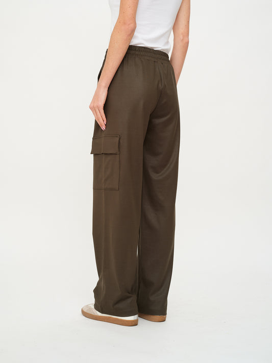 Back View of Women’s coated cargo trousers in olive with drawstring waist and pockets