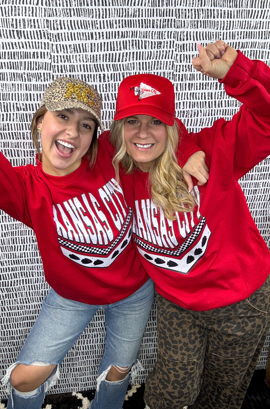 Two Women wearing Red Kansas City Sweatshirt with graphic arrow design