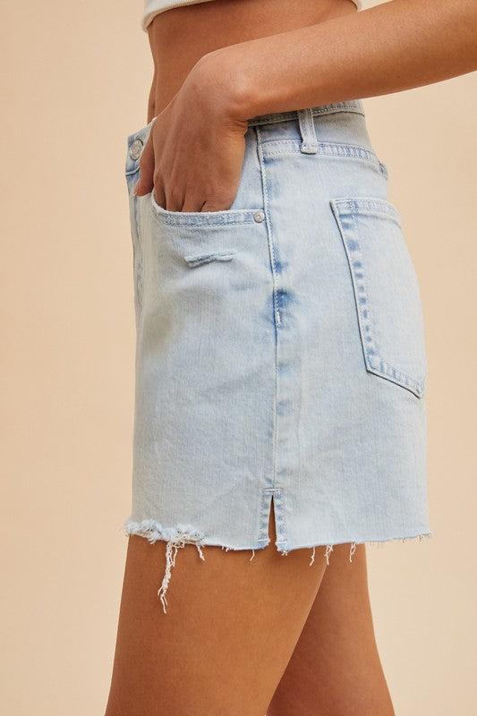High-rise light wash denim skirt with raw hem and side slit, trendy summer fashion for women