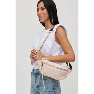 Woman wearing Celine belt bag with gold rings strap.