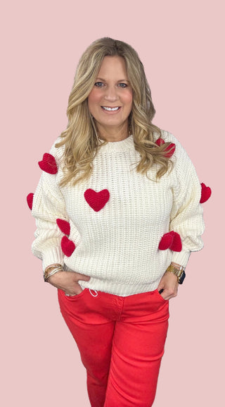 Cream chunky knit sweater with red heart appliqué details for women  available at Erin Rose Boutique