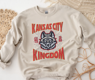 A beige sweatshirt with 'KANSAS CITY CHIEFS' and a wolf graphic in red and blue.