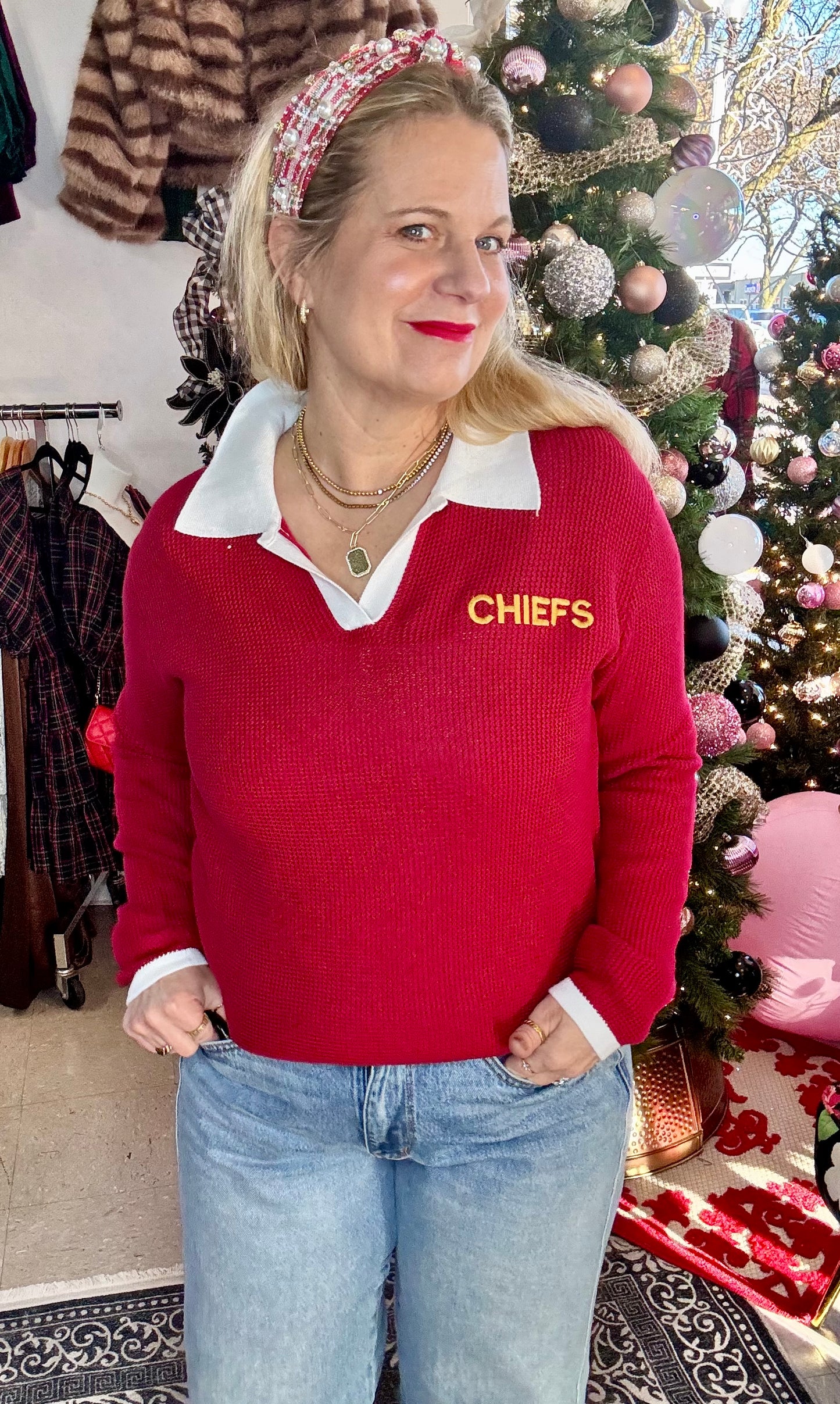Red collared game day sweater with Chiefs lettering styled with denim - at Ern Rose Boutique