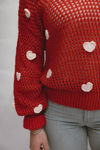 Red knitted sweater with pink hearts  available at Erin Rose boutique
