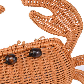 Close-up of the Sebastian Woven Crab Clutch Bag showcasing its woven texture, crab silhouette