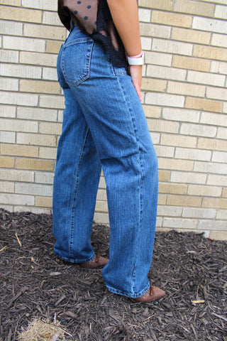A person wearing JBD Square Patch Pocket Straight Jeans denim jeans showing side view