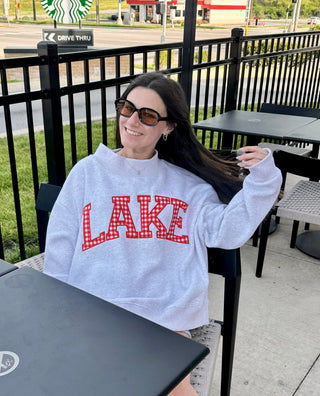 Women's lake sweatshirt styled with shorts for a casual lake-day outfit.