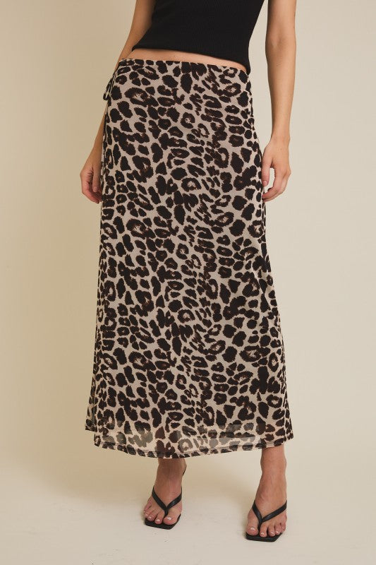 Woman wearing a leopard print maxi skirt with wrap detail and flowy silhouette