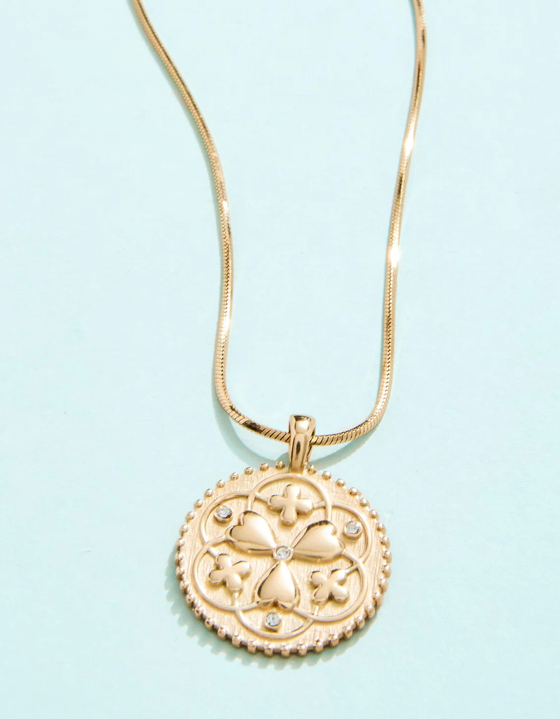Gold clover medallion necklace with heart and crystal accents on gold chain – Erin Rose Boutique