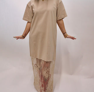 Model wearing a taupe oversized t-shirt style maxi dress with sheer lace hem detail and short sleeves.
