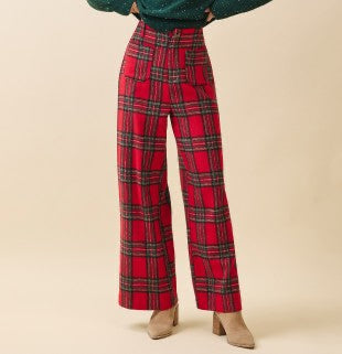 Red plaid pants worn by a person on a beige background