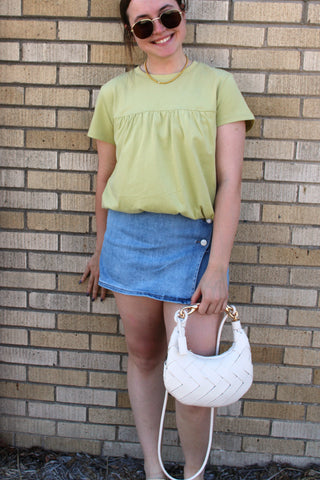 Woman wearing the remi risen high rise skort with bubble green top