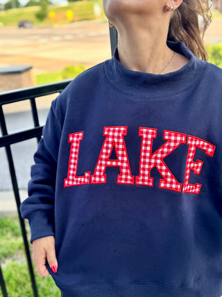 Lake-themed oversized sweatshirt with red gingham letters.