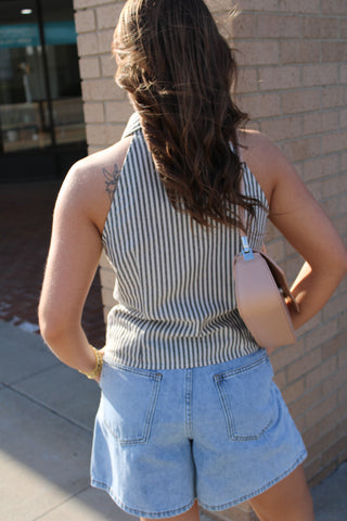 Back View of Black and white striped sleeveless collared blouse with button front styling paired with relaxed denim shorts for an effortless summer outfit