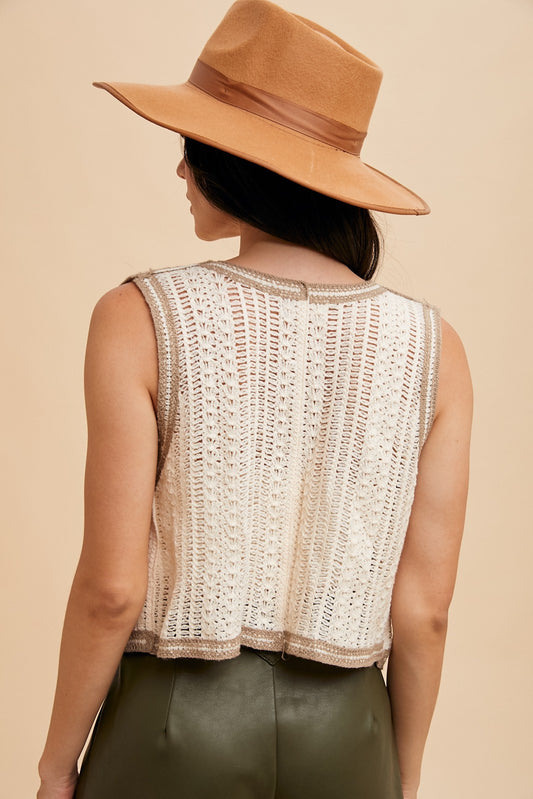 Back view of a woman wearing a cream and taupe open-knit crochet vest – sleeveless textured sweater top for women