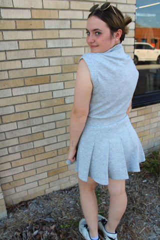 back view grey scuba romper with zip front and skirt overlay women's athletic outfit