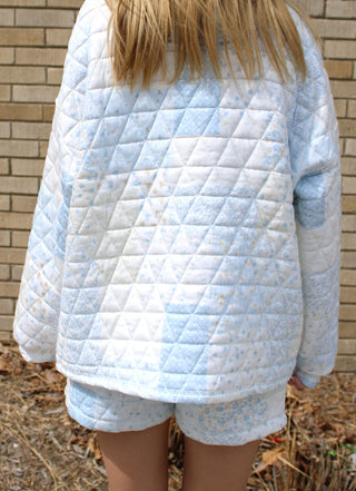 back of model wearing blue quilted patchwork pullover with half zip and relaxed fit styled as part of a matching set from Erin Rose Boutique