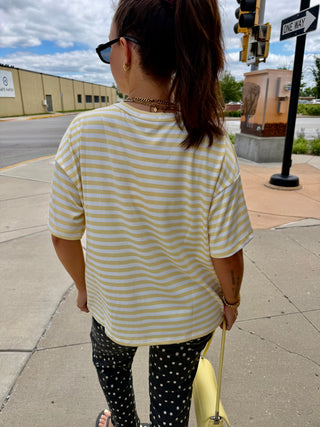 Close-up of the Butter Yellow Lennon Striped Top featuring soft yellow and white stripes in a relaxed oversized fit.