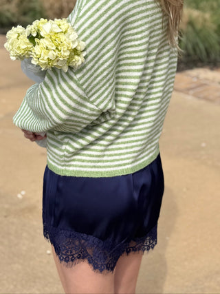 Back view of Abby Rose Mini Striped Piper Cardigan in matcha green and ivory stripes, lightweight knit button up sweater available at ERB