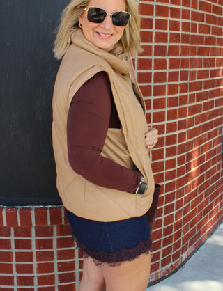 Beige quilted vest with front zipper closure