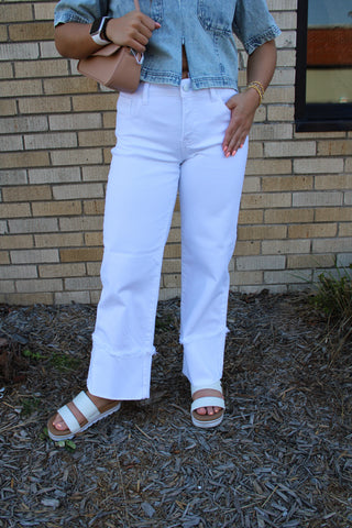 Women wearing white Risen tummy control jeans with wide cuff hem and high rise fit available at Erin Rose Boutique