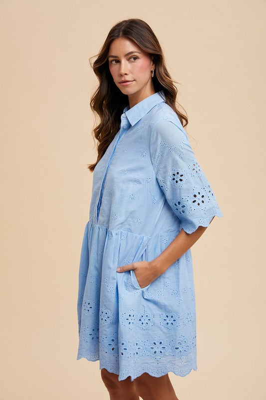 Side view of a light blue eyelet babydoll dress with floral cutouts, scalloped edges, and pockets—perfect for feminine summer fashion