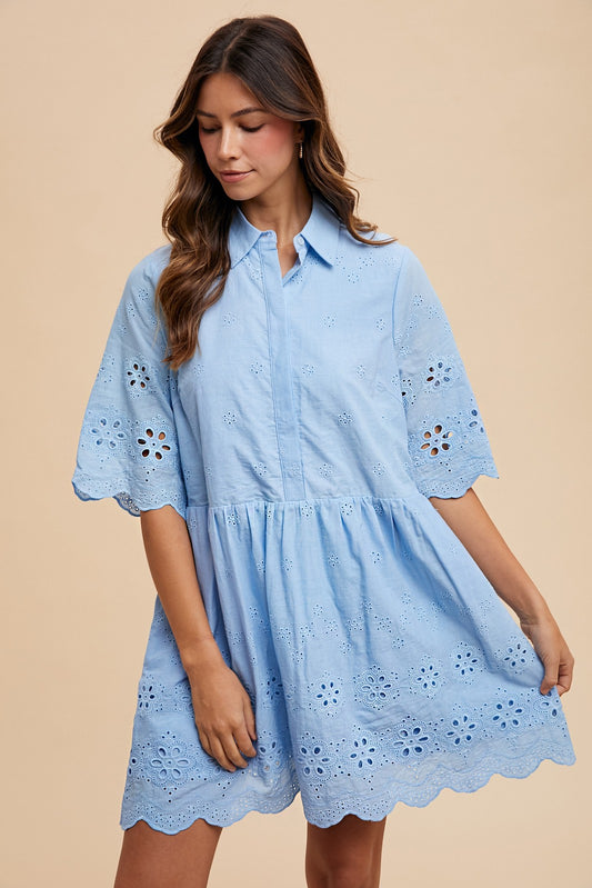 Woman wearing a light blue eyelet babydoll dress with scalloped hem and floral embroidery, perfect for spring and summer outfits for women in their 30s and 40s