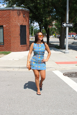Blue garden-inspired mini dress with detailed floral embroidery styled for a casual summer outfit.