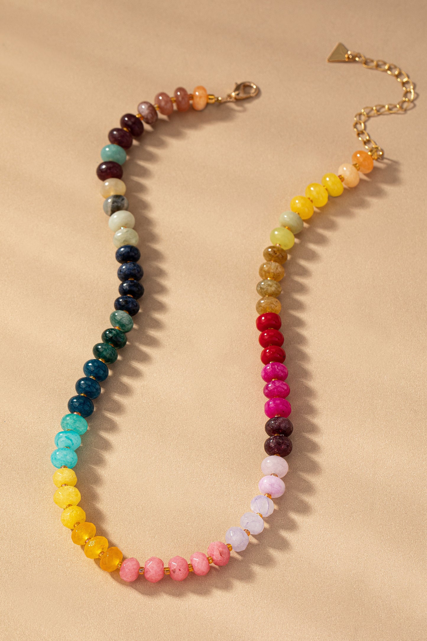 Bold rainbow necklace with jewel-toned gradient agate beads and gold adjustable chain clasp