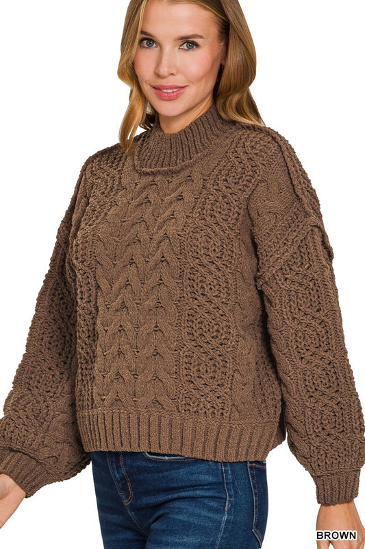 Woman wearing a brown cable knit sweater on a white background