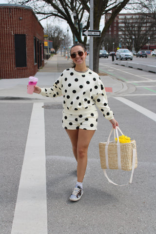 Person walking in a polka dot butter yellow matching lounge set
