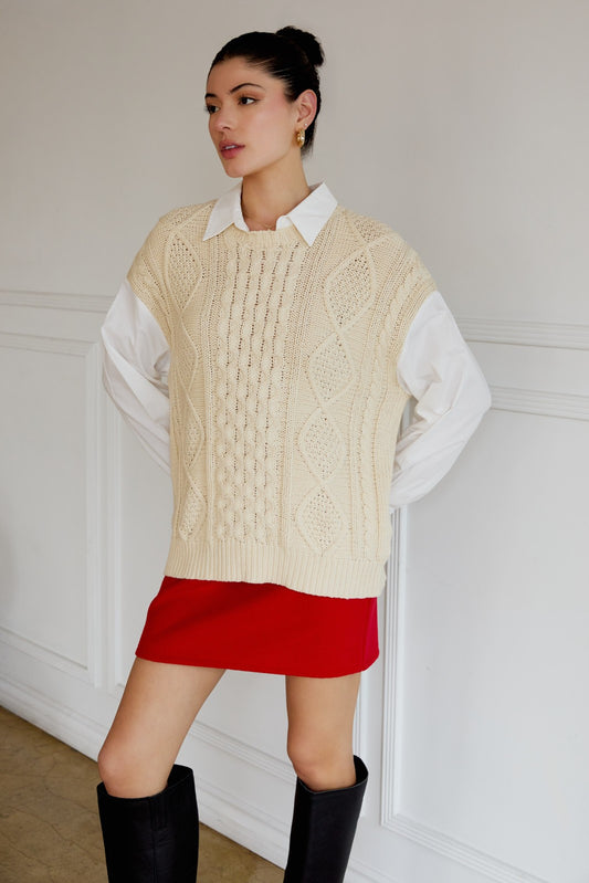 Woman wearing a beige cable knit sweater with built in white shirt available at Erin Rose Boutique
