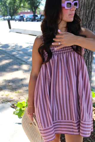 Women wearing Casual cami striped mini dress with smocked top available at Erin Rose Boutique