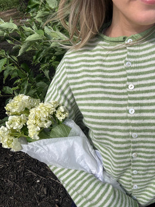 Close up of Abby Rose Mini Striped Piper Cardigan in matcha green and ivory stripes, lightweight knit button front sweater available at ERB.