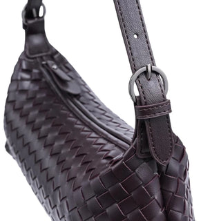 close up view of chocolate woven handbag  shoulder strap and woven design