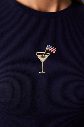 Navy blue ribbed baby tee closeup with embroidered martini glass and American flag design.