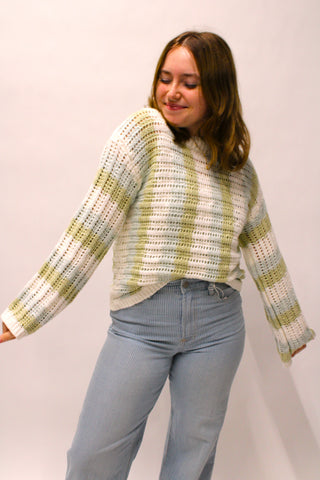 Coastal Clouds cream and sage striped open knit sweater styled with blue denim pants