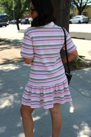 Back view of the Court Club Striped Polo Mini Dress featuring colorful horizontal stripes, short sleeves, and a feminine ruffle hem.