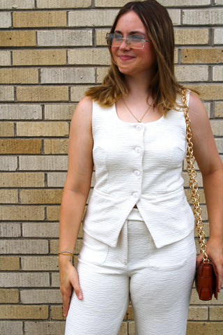 Woman wearing Zoey Tailored Button Top in cream textured fabric with a flattering tailored fit.