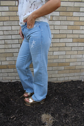 Women's embroidered star jeans in light blue denim side view