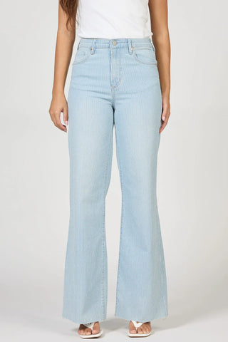 Light blue railroad striped flared jeans worn by a woman available at erin rose boutique