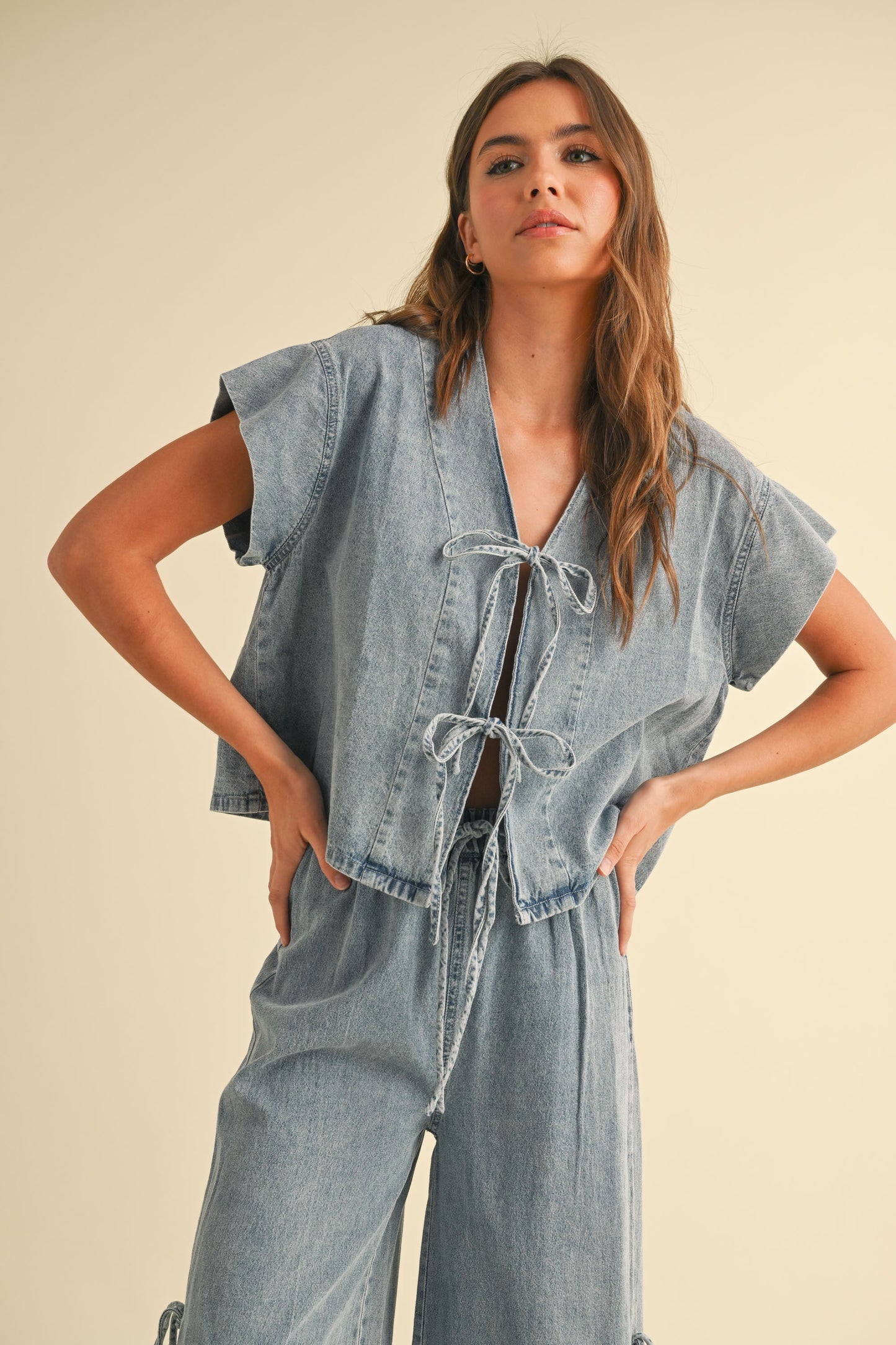 Front view of denim cap sleeve crop top with tie-front detail and boxy fit available at Erin Rose Boutique

