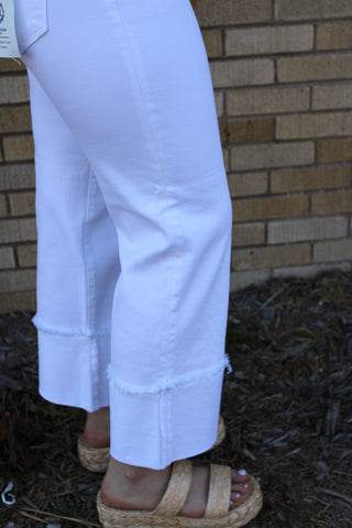 Close up view of cuffed detail on risen white cuffed jeans available at Erin Rose Boutique