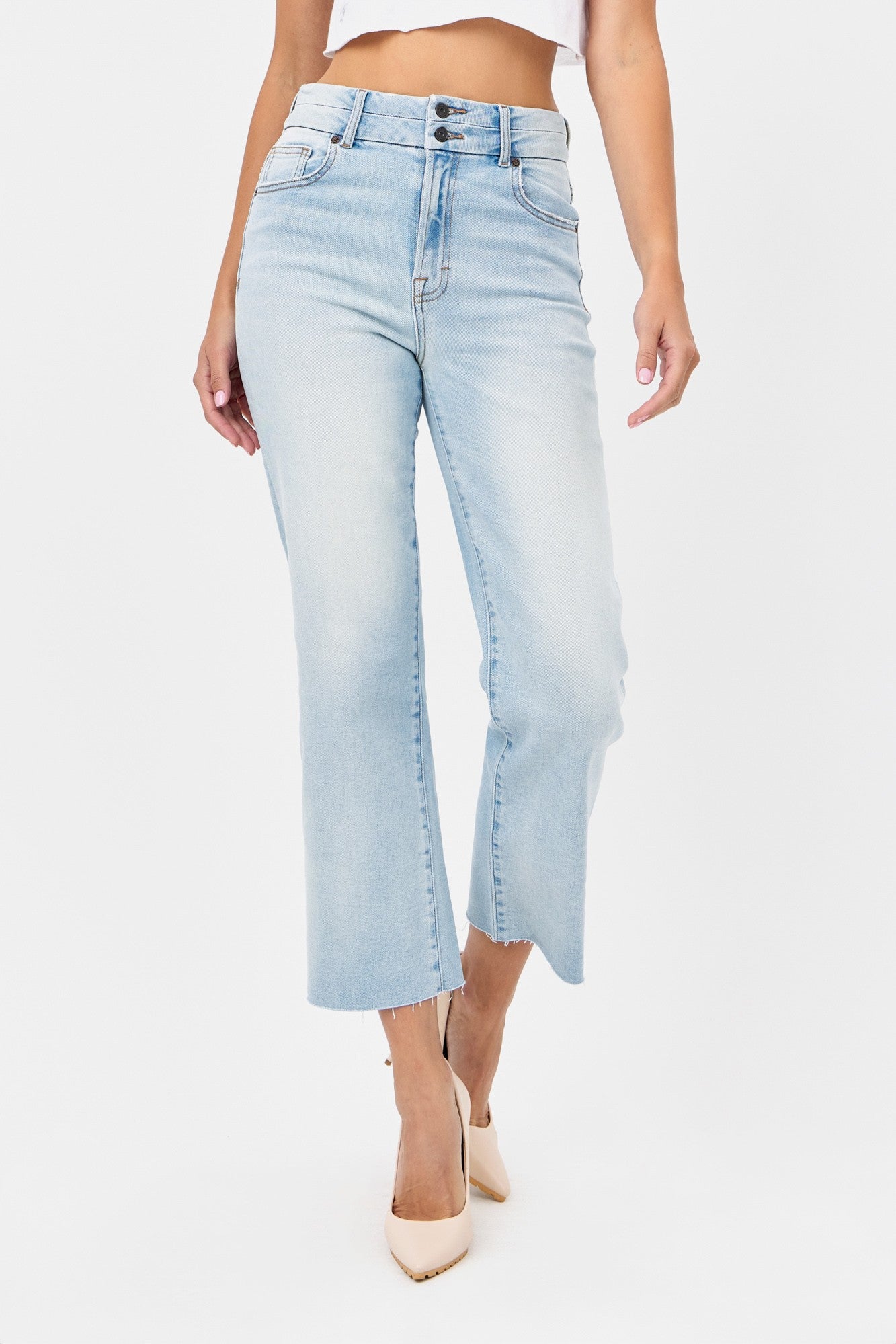 A pair of light blue denim wide leg jeans with a high waist and hidden waistband design.