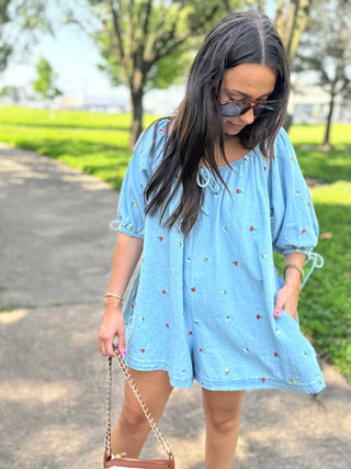 Floral embroidered denim romper with short puff sleeves and relaxed fit