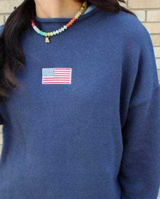 Lightweight navy sweater with classic flag detail.