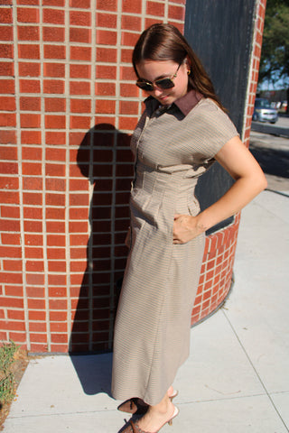     Side view of Emily houndstooth midi dress showing fitted waist, pleated skirt and side pocket