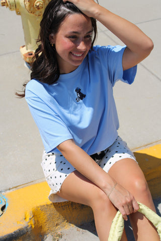 Blue embroidered pup soccer tee styled with polka dot denim shorts