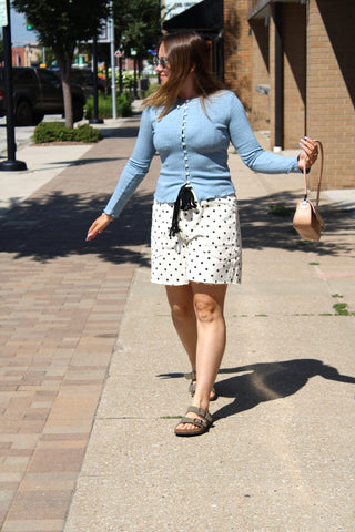 Women's fitted blue cardigan with a ribbed texture and classic button-front design.