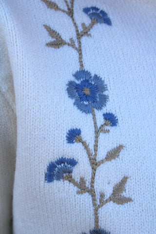Blue floral embroidery close up of detail on ivory Flora Embroidered Knit Sweater